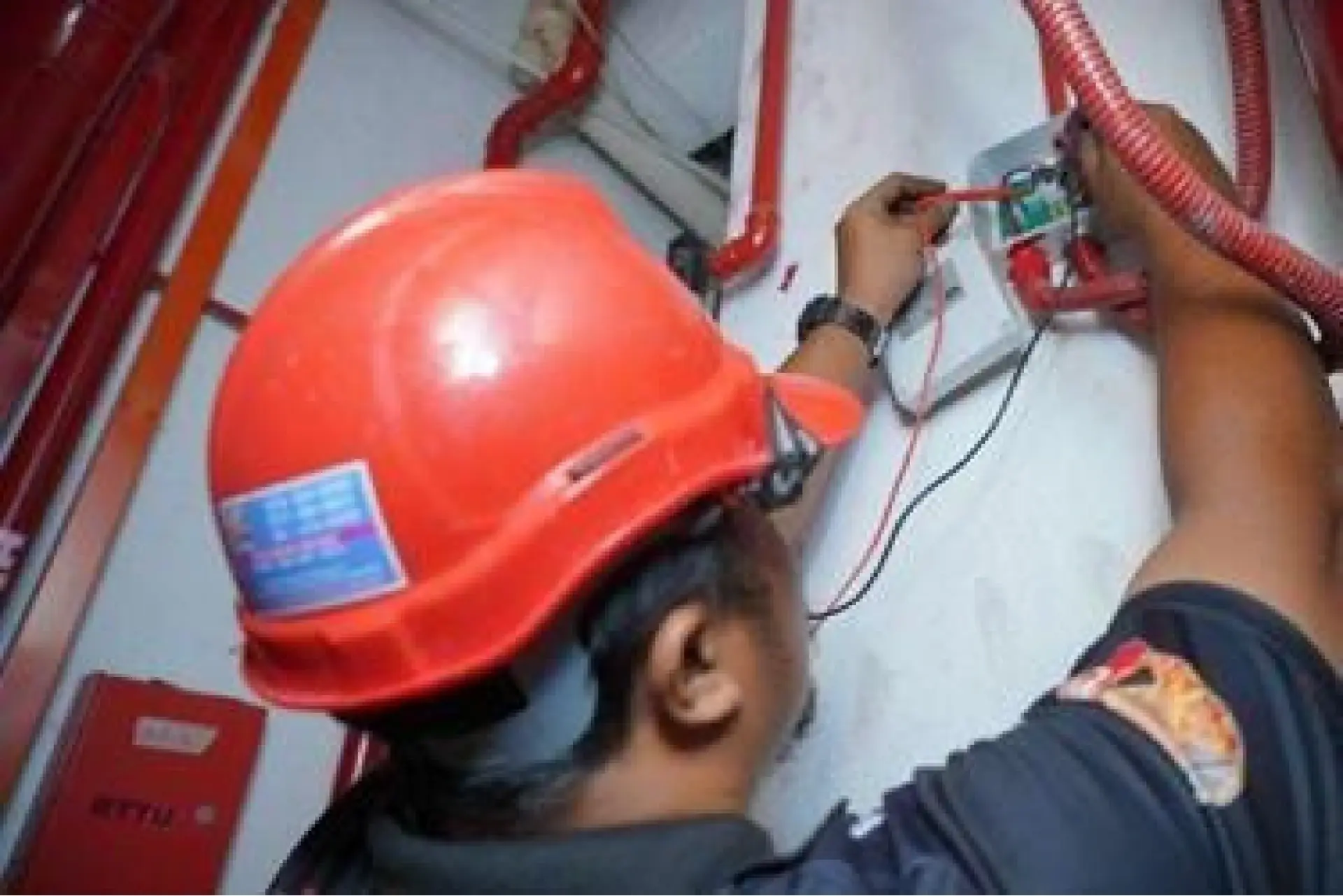 Technician testing a fire alarm panel