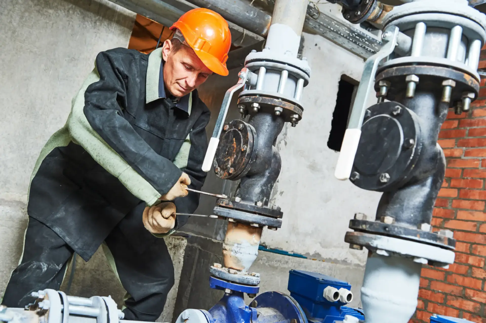 Engineer working on industrial pipe valves